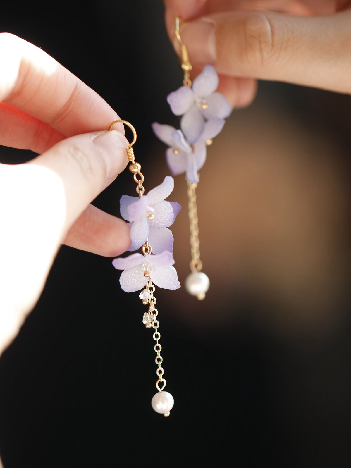 Purple flower earring detail with long chain and pale drop