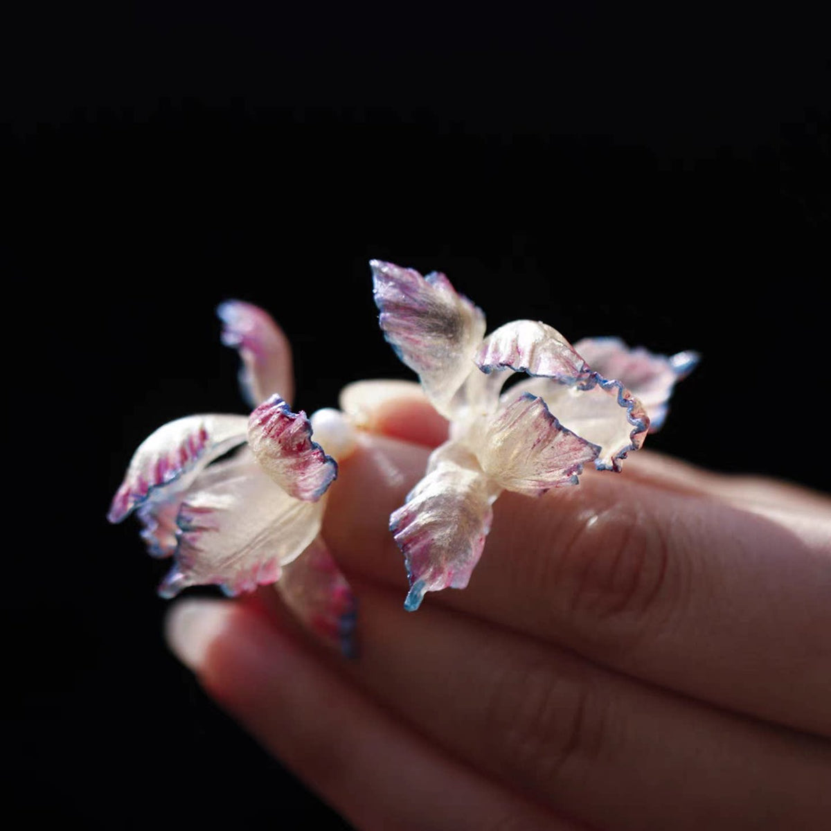 Close view of layered iris petals and earring drops