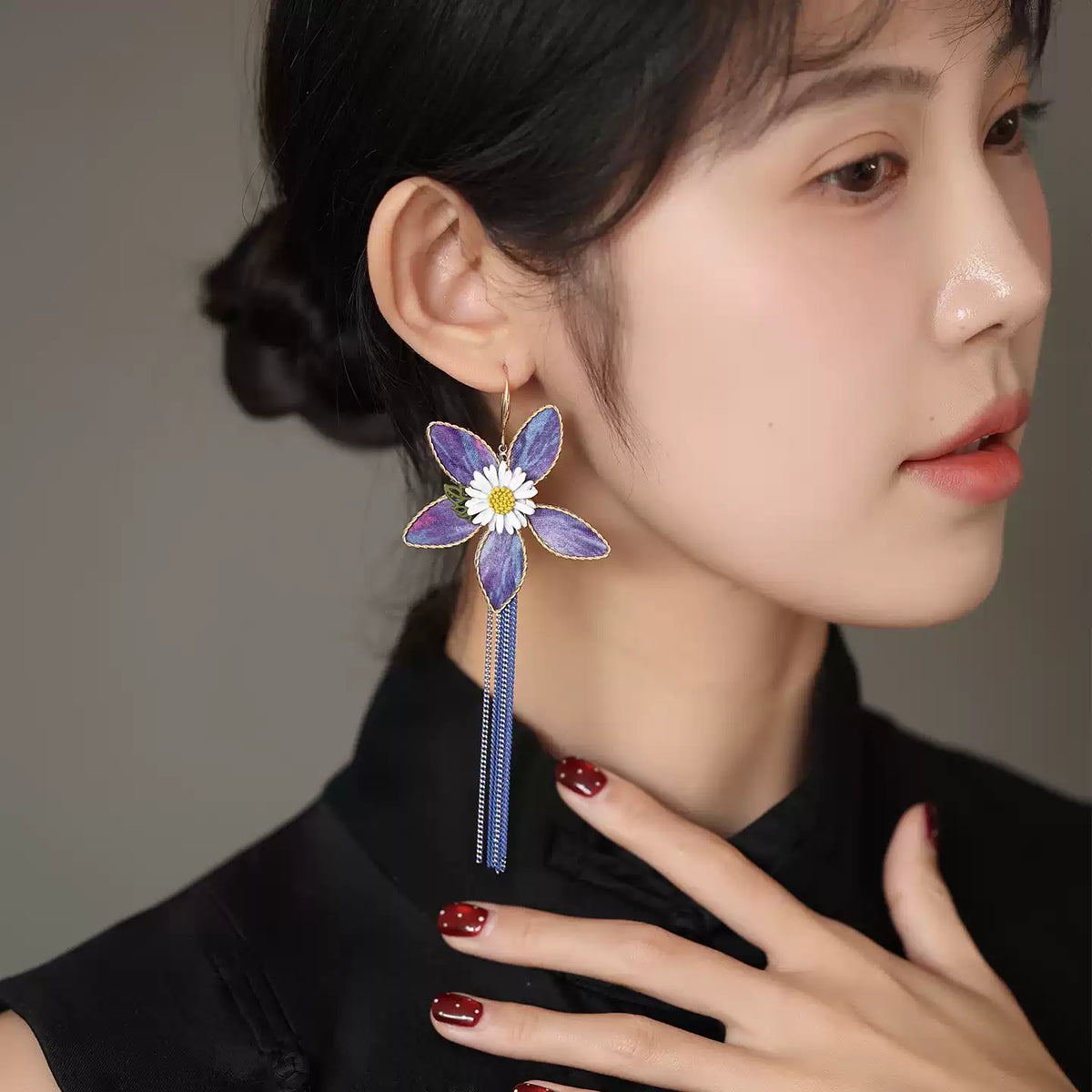 Additional worn view of purple floral drop earrings