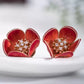 Close-up of the red plum blossom stud earrings