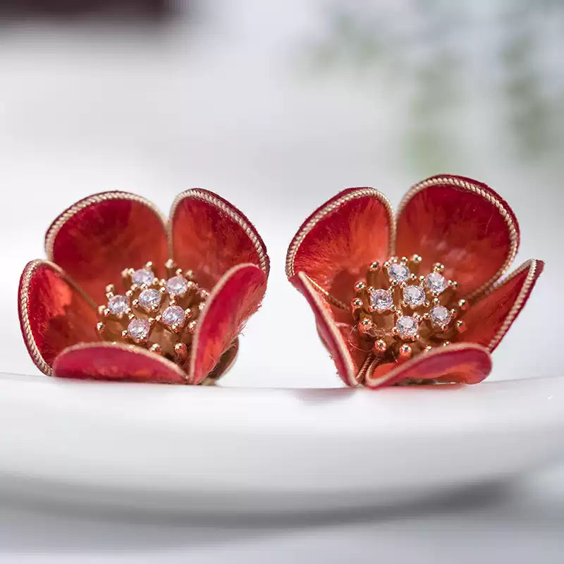 Close-up of the red plum blossom stud earrings