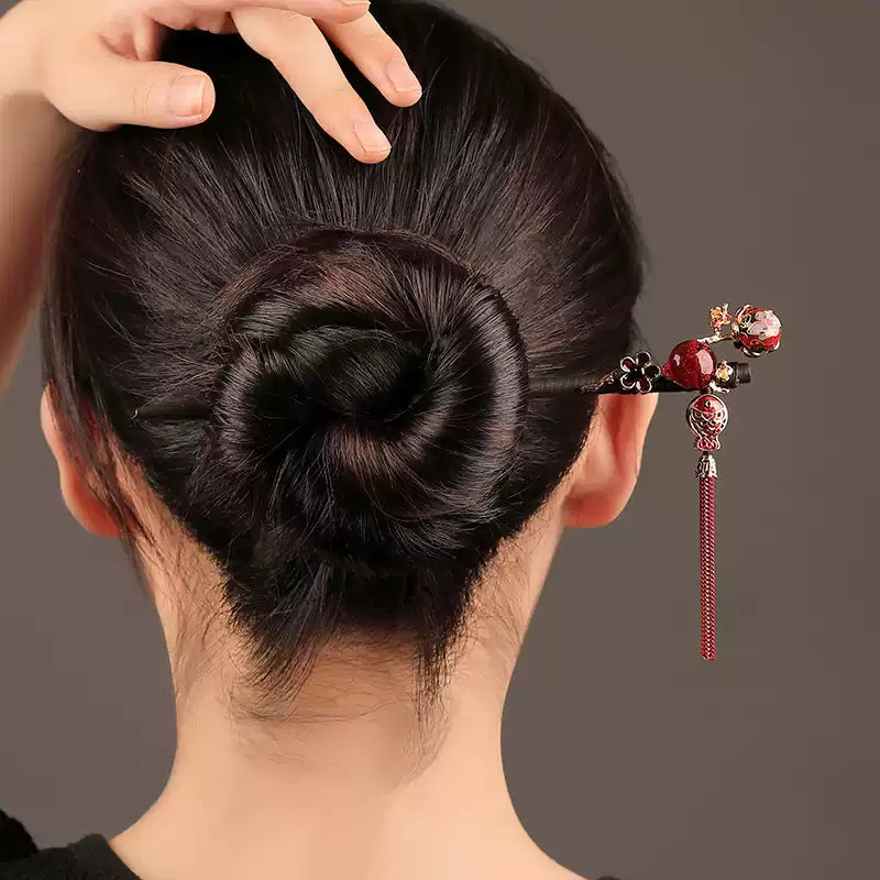 Red hanging tassel hairpin worn in an updo