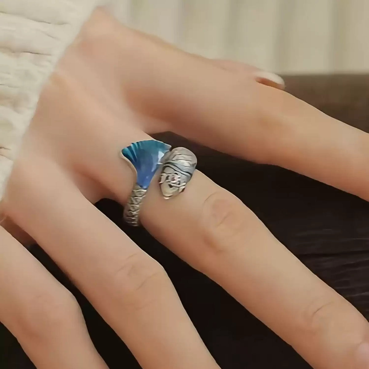 Open adjustable ring shown from the side with koi and floral details