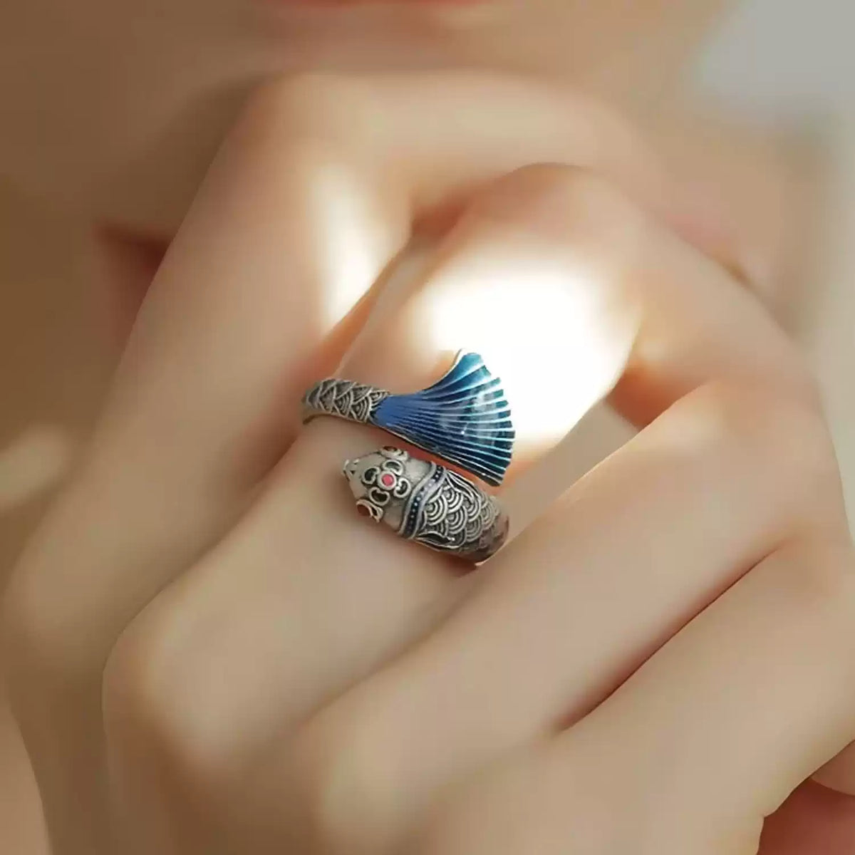 Detailed view of the koi and begonia ring with blue and red accents