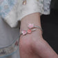 Side view of the cherry blossom cuff bracelet worn on the wrist