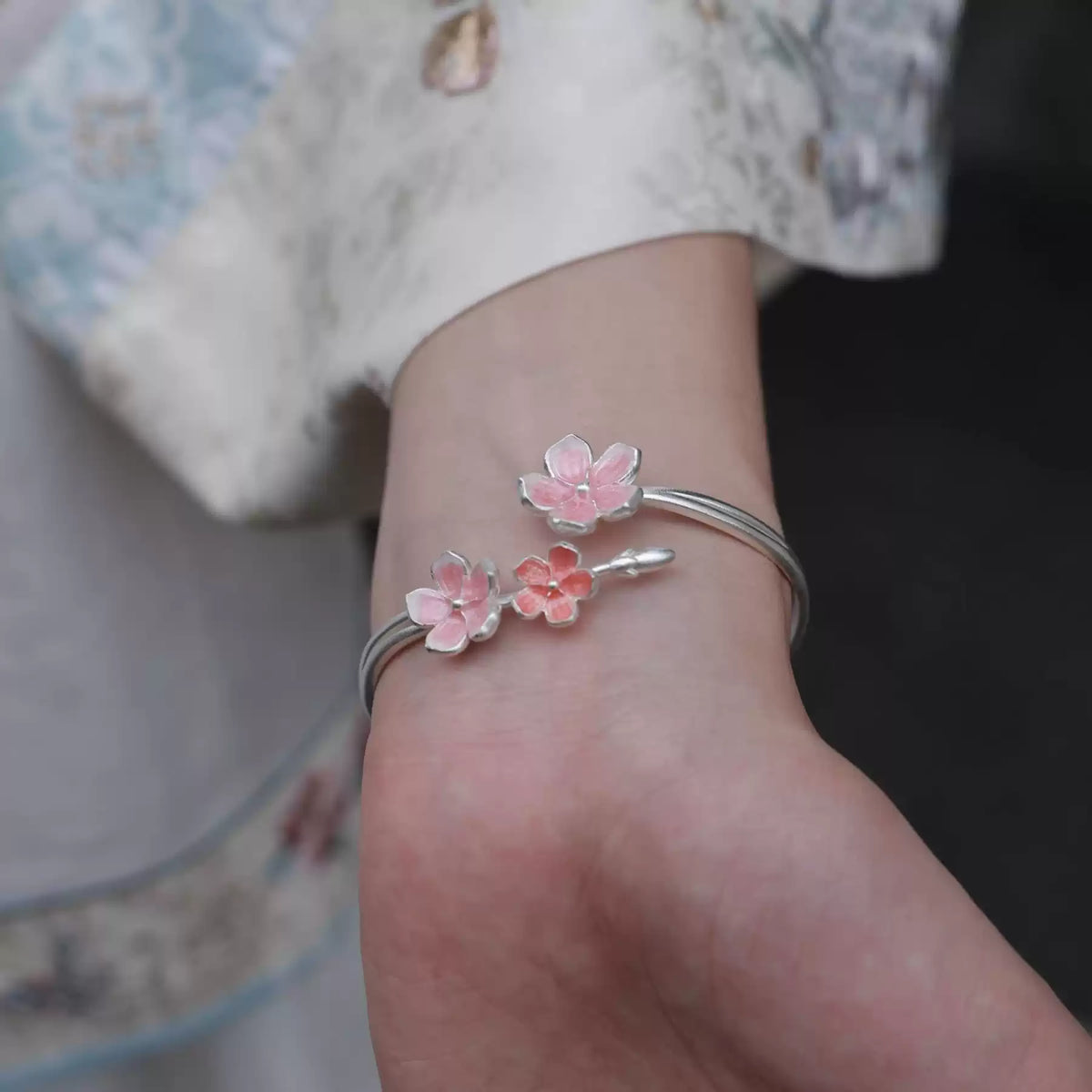 Side view of the cherry blossom cuff bracelet worn on the wrist
