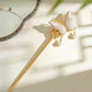 Close-up of the double-sided butterfly hair ornament in pale blue and pink textile