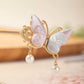 Detailed view of the brocade butterfly wings and pearl-style drops