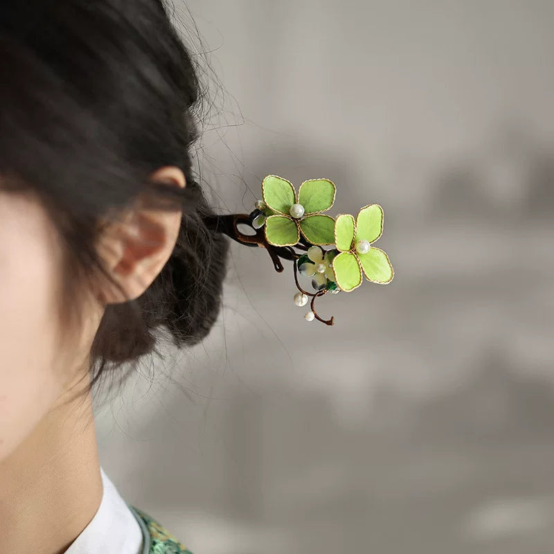 Side view of the floral hair stick secured in a bun