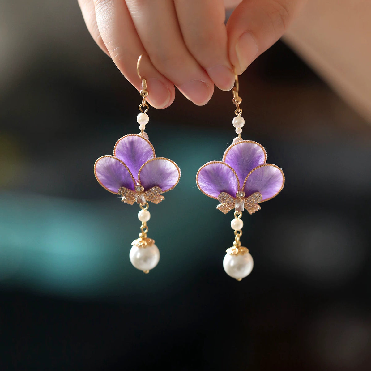 Front view of the pair of violet flower drop earrings