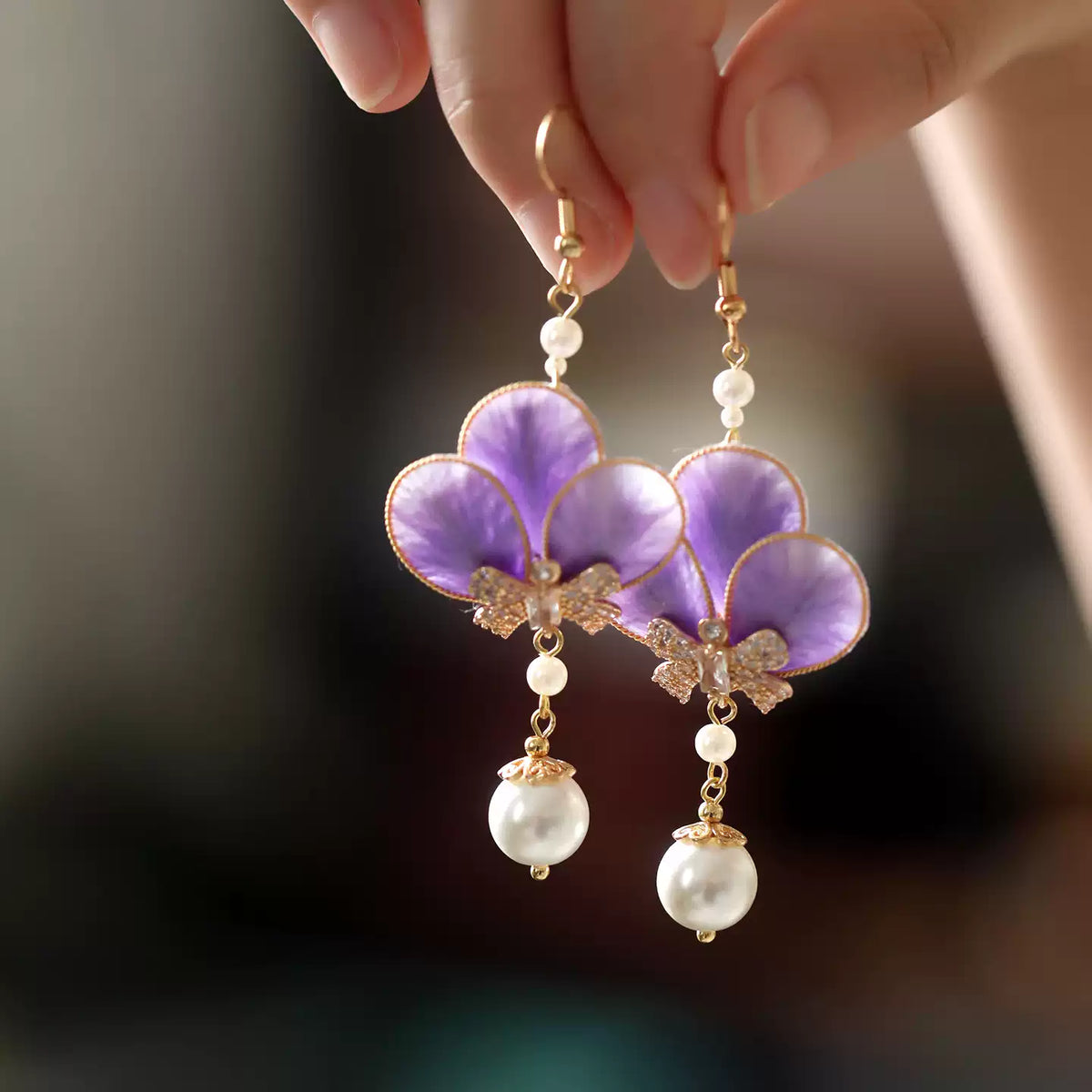 Pair of violet floral drop earrings with white bead accents