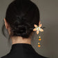 Wooden hair stick styled in a low bun