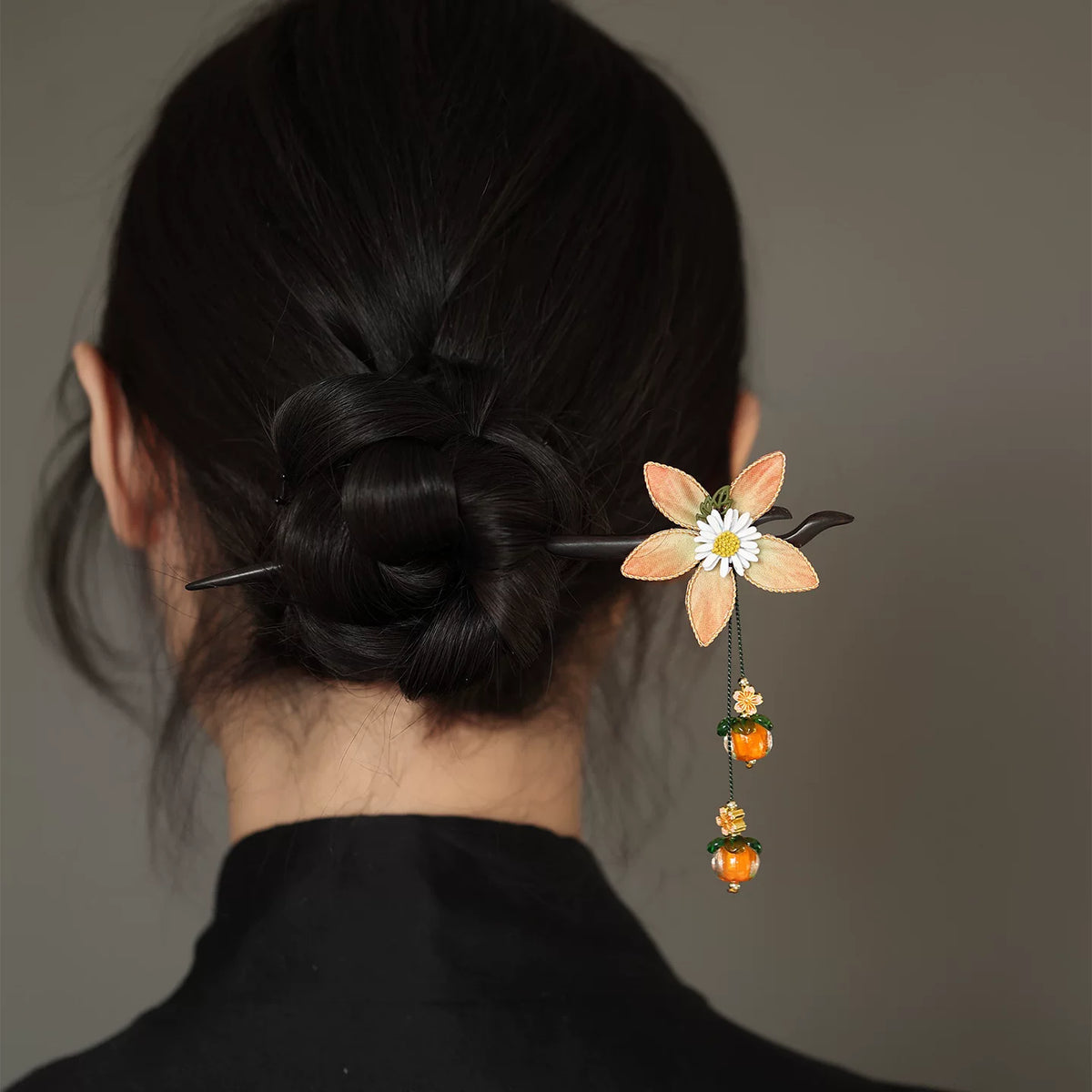 Wooden hair stick styled in a low bun