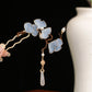 Close-up detail of yellow silk ginkgo leaf hairpin with faux pearl accent