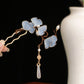 Yellow ginkgo leaf hairpin worn in a traditional style updo